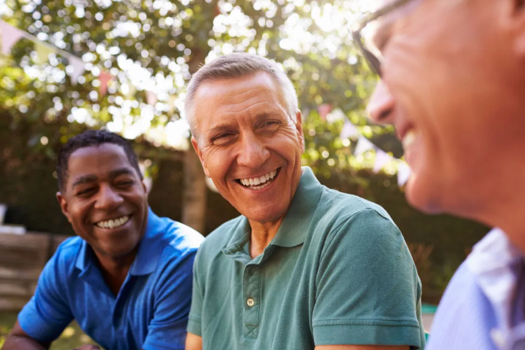 Men Smiling sitting next to each other